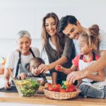 family preparing a healthy meal to help with nutrition and oral health