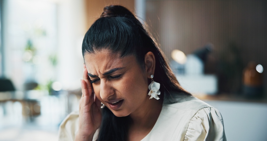 woman with headache from TMJ jaw pain